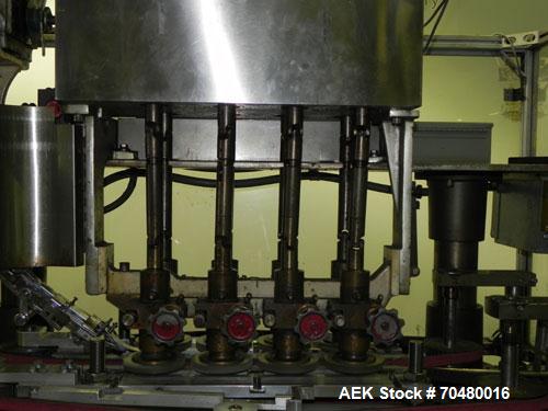 Used Resina Model U40-663 Automatic Inline Capper. Machine is capable of speeds up to 300 caps per minute. Adjustable from 10mm-70mm caps. Has top mounted cap sorter with hopper. Machine has 2HR pin ...