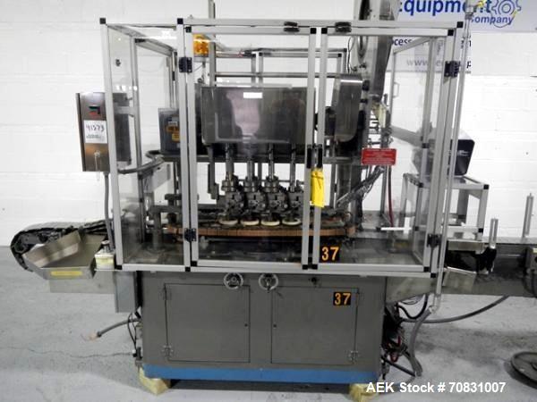 Used Resina Model U40 Automatic Inline Capper. Machine is capable of speeds up to 300 caps per minute. Is a 4 station capper with 8 spindle quills. Adjustable from 10mm-70mm caps. Has top mounted cap...