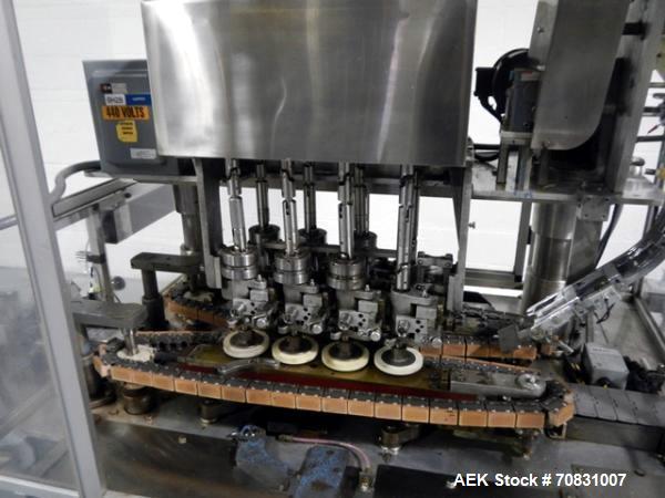 Used Resina Model U40 Automatic Inline Capper. Machine is capable of speeds up to 300 caps per minute. Is a 4 station capper with 8 spindle quills. Adjustable from 10mm-70mm caps. Has top mounted cap...