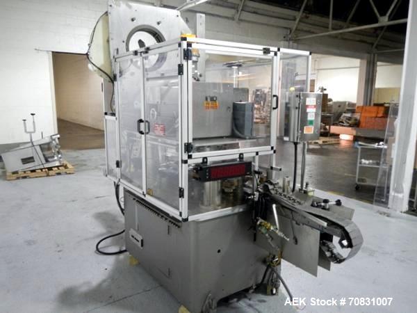 Used Resina Model U40 Automatic Inline Capper. Machine is capable of speeds up to 300 caps per minute. Is a 4 station capper with 8 spindle quills. Adjustable from 10mm-70mm caps. Has top mounted cap...