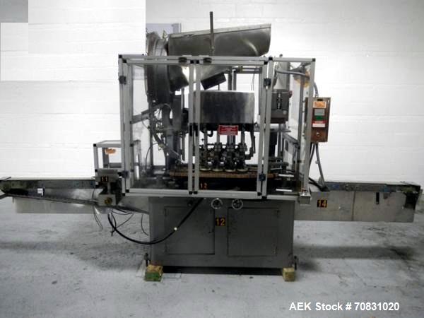 Used Resina Model U40 Automatic Inline Capper. Machine is capable of speeds up to 300 caps per minute. Is a 4 station capper with 8 spindle quills. Adjustable from 10mm-70mm caps. Has top mounted cap...