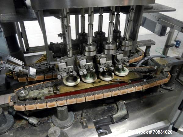 Used Resina Model U40 Automatic Inline Capper. Machine is capable of speeds up to 300 caps per minute. Is a 4 station capper with 8 spindle quills. Adjustable from 10mm-70mm caps. Has top mounted cap...
