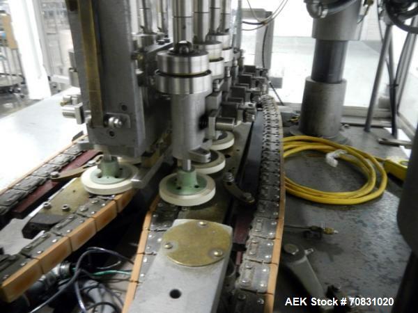 Used Resina Model U40 Automatic Inline Capper. Machine is capable of speeds up to 300 caps per minute. Is a 4 station capper with 8 spindle quills. Adjustable from 10mm-70mm caps. Has top mounted cap...