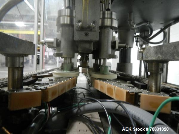 Used Resina Model U40 Automatic Inline Capper. Machine is capable of speeds up to 300 caps per minute. Is a 4 station capper with 8 spindle quills. Adjustable from 10mm-70mm caps. Has top mounted cap...