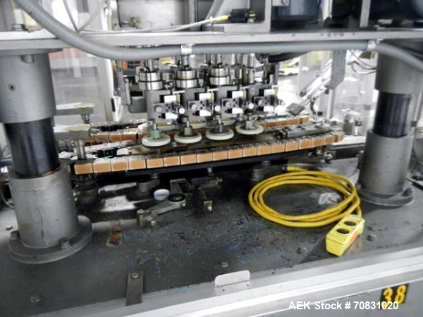 Used Resina Model U40 Automatic Inline Capper. Machine is capable of speeds up to 300 caps per minute. Is a 4 station capper with 8 spindle quills. Adjustable from 10mm-70mm caps. Has top mounted cap...