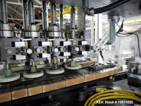 Used Resina Model U40 Automatic Inline Capper. Machine is capable of speeds up to 300 caps per minute. Is a 4 station capper with 8 spindle quills. Adjustable from 10mm-70mm caps. Has top mounted cap...