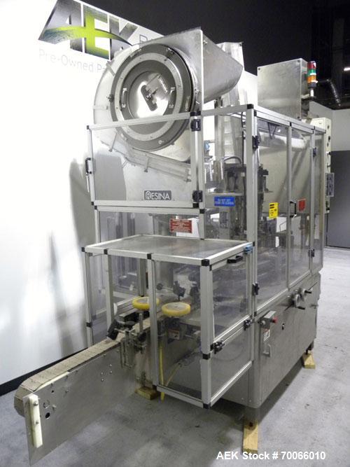 Used Resina Inline Quill Capper, 8 Quill, Model UN40-1250. Capable of speeds over 250 Bottles per minute. Has a cap size range from 13 - 70mm (with changeparts). Has a vertical pin style sorter for c...