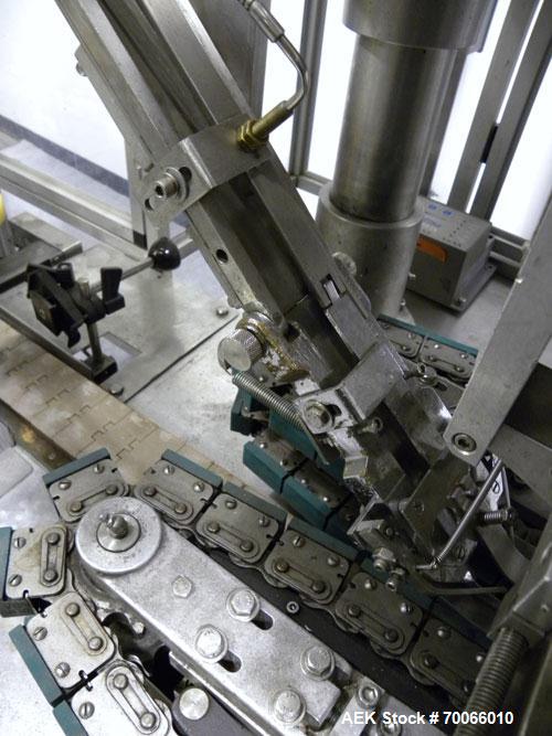 Used Resina Inline Quill Capper, 8 Quill, Model UN40-1250. Capable of speeds over 250 Bottles per minute. Has a cap size range from 13 - 70mm (with changeparts). Has a vertical pin style sorter for c...
