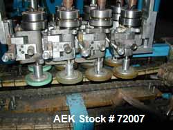 Usedina model U-40 automatic screw capper, 4 quill straight conveyorized dual gripper. Approximate cap range: 13 to 38mm or 43 to 70mm. Approximate speed range: 60-150 per minute. Container range: 1/...