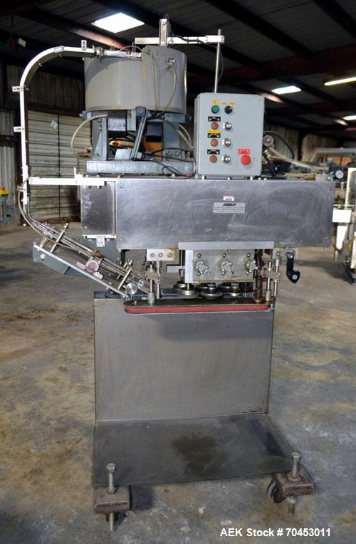 Used Sure Kap SK6000 Quill capper. Three spindle capper with adjustable chute will handle caps from 13 to 110MM w/o changeparts. Has dual gripper belts, C frame construction will mount up to any conv...