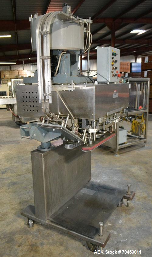 Used Sure Kap SK6000 Quill capper. Three spindle capper with adjustable chute will handle caps from 13 to 110MM w/o changeparts. Has dual gripper belts, C frame construction will mount up to any conv...