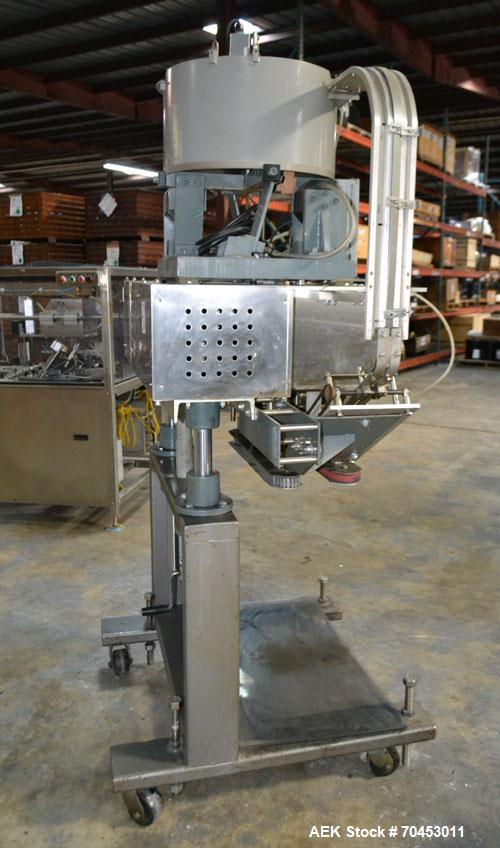 Used Sure Kap SK6000 Quill capper. Three spindle capper with adjustable chute will handle caps from 13 to 110MM w/o changeparts. Has dual gripper belts, C frame construction will mount up to any conv...