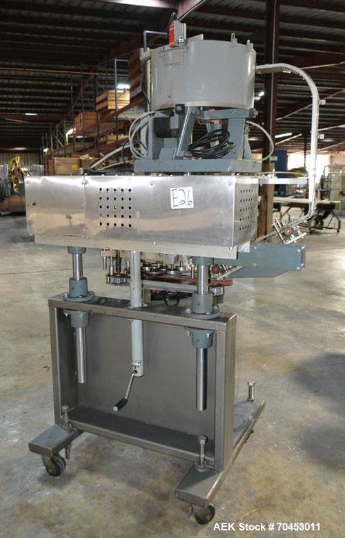 Used Sure Kap SK6000 Quill capper. Three spindle capper with adjustable chute will handle caps from 13 to 110MM w/o changeparts. Has dual gripper belts, C frame construction will mount up to any conv...