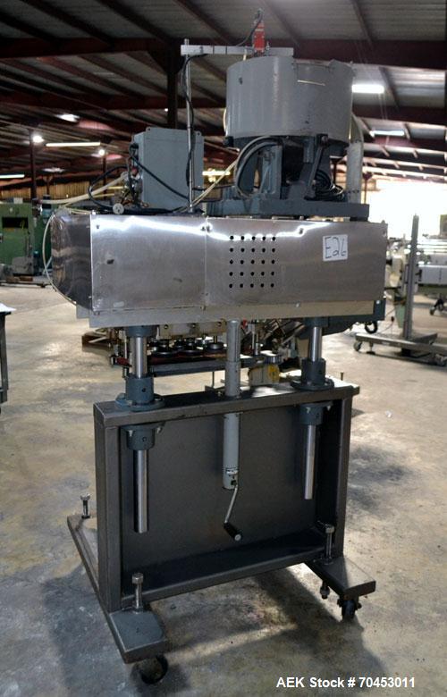 Used Sure Kap SK6000 Quill capper. Three spindle capper with adjustable chute will handle caps from 13 to 110MM w/o changeparts. Has dual gripper belts, C frame construction will mount up to any conv...