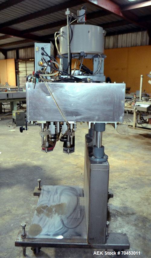 Used Sure Kap SK6000 Quill capper. Three spindle capper with adjustable chute will handle caps from 13 to 110MM w/o changeparts. Has dual gripper belts, C frame construction will mount up to any conv...
