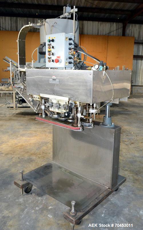 Used Sure Kap SK6000 Quill capper. Three spindle capper with adjustable chute will handle caps from 13 to 110MM w/o changeparts. Has dual gripper belts, C frame construction will mount up to any conv...