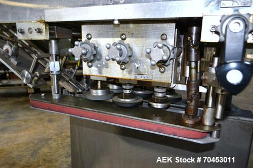 Used Sure Kap SK6000 Quill capper. Three spindle capper with adjustable chute will handle caps from 13 to 110MM w/o changeparts. Has dual gripper belts, C frame construction will mount up to any conv...