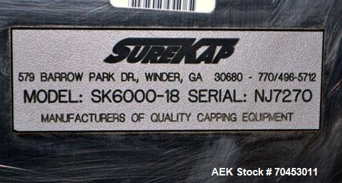 Used Sure Kap SK6000 Quill capper. Three spindle capper with adjustable chute will handle caps from 13 to 110MM w/o changeparts. Has dual gripper belts, C frame construction will mount up to any conv...