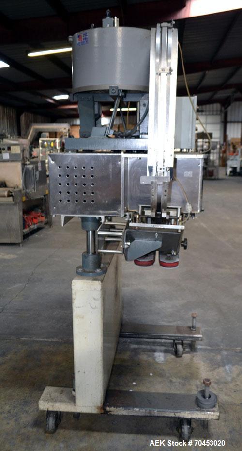 Used Sure Kap SK6000-18 Quill capper. Three spindle capper with adjustable chute will handle caps from 13 to 110MM w/o changeparts. Has dual gripper belts, C frame construction will mount up to any c...