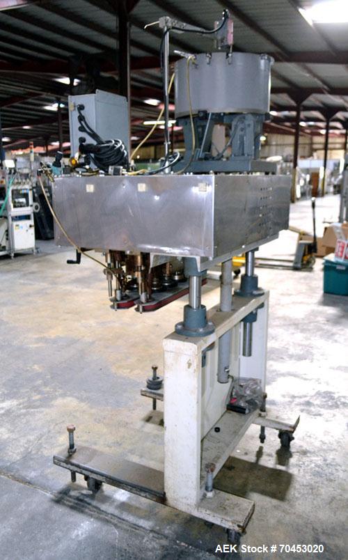 Used Sure Kap SK6000-18 Quill capper. Three spindle capper with adjustable chute will handle caps from 13 to 110MM w/o changeparts. Has dual gripper belts, C frame construction will mount up to any c...