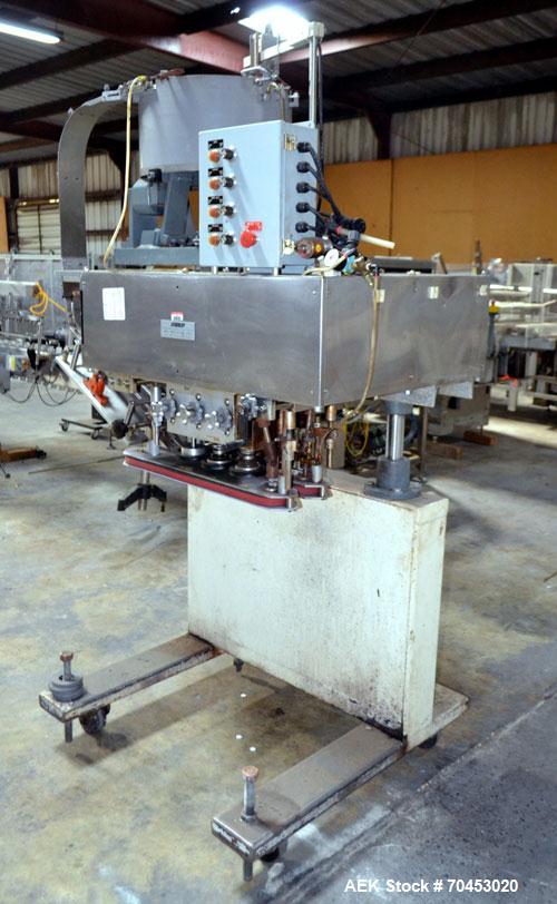 Used Sure Kap SK6000-18 Quill capper. Three spindle capper with adjustable chute will handle caps from 13 to 110MM w/o changeparts. Has dual gripper belts, C frame construction will mount up to any c...