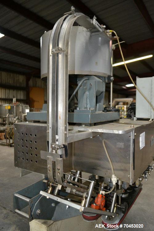 Used Sure Kap SK6000-18 Quill capper. Three spindle capper with adjustable chute will handle caps from 13 to 110MM w/o changeparts. Has dual gripper belts, C frame construction will mount up to any c...