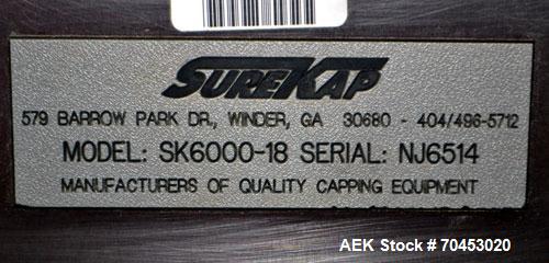 Used Sure Kap SK6000-18 Quill capper. Three spindle capper with adjustable chute will handle caps from 13 to 110MM w/o changeparts. Has dual gripper belts, C frame construction will mount up to any c...