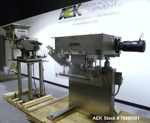 Used SureKap Fully Automatic Straight Line Six Spindle Quill Capper, Model SK6000-SP. Capacities 100 bottles per minute depending on size and conveyor speed. Cap Size Range: diameter 8mm to 110mm (Ma...