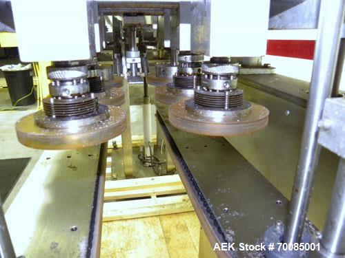 Used SureKap Fully Automatic Straight Line Six Spindle Quill Capper, Model SK6000-SP. Capacities 100 bottles per minute depending on size and conveyor speed. Cap Size Range: diameter 8mm to 110mm (Ma...