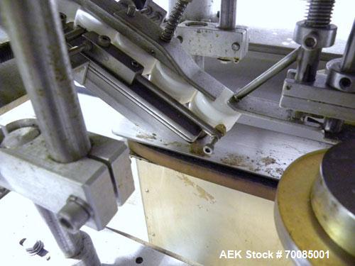 Used SureKap Fully Automatic Straight Line Six Spindle Quill Capper, Model SK6000-SP. Capacities 100 bottles per minute depending on size and conveyor speed. Cap Size Range: diameter 8mm to 110mm (Ma...