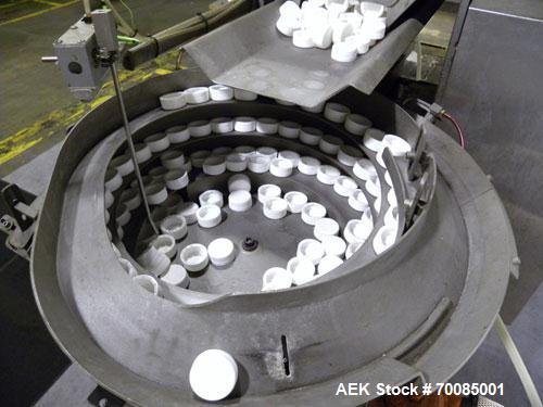 Used SureKap Fully Automatic Straight Line Six Spindle Quill Capper, Model SK6000-SP. Capacities 100 bottles per minute depending on size and conveyor speed. Cap Size Range: diameter 8mm to 110mm (Ma...