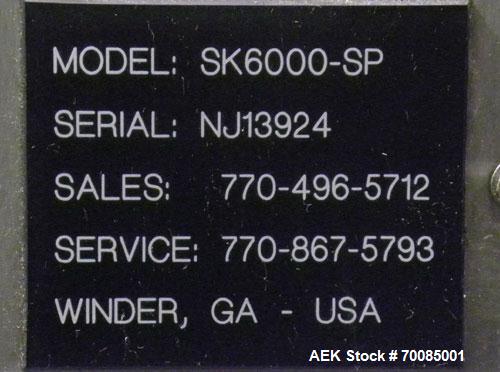 Used SureKap Fully Automatic Straight Line Six Spindle Quill Capper, Model SK6000-SP. Capacities 100 bottles per minute depending on size and conveyor speed. Cap Size Range: diameter 8mm to 110mm (Ma...