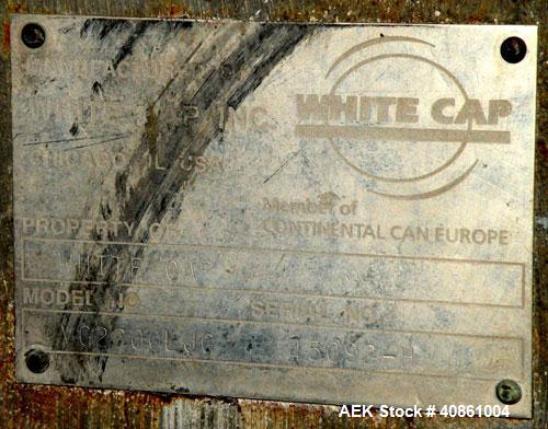 Used White Cap Vacuum Steam Flow Capper, Model VG2200LJG. Includes a cap hopper, and a 4 1/2" wide x 132" long conveyor. Machine was last running a 58mm cap.