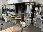 Used Kapsall Model A2 Inline Screw Capper. Capable of speeds up to 150 bottles per minute. Has single bottle grippers, three pair spindles  with adjustable cap chute and integrated cap elevator. Cap ...