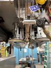 Used Kapsall Model A2 Inline Screw Capper. Capable of speeds up to 150 bottles per minute. Has single bottle grippers, three pair spindles  with adjustable cap chute and integrated cap elevator. Cap ...