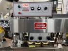 Used Kapsall Model A2 Inline Screw Capper. Capable of speeds up to 150 bottles per minute. Has single bottle grippers, three pair spindles  with adjustable cap chute and integrated cap elevator. Cap ...