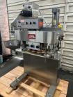 Used Kapsall Model A 2Inline Screw Capper. Capable of speeds up to 150 bottles per minute. Has single bottle grippers, three pair spindles  with adjustable cap chute and integrated cap elevator. Cap ...