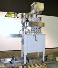 Used Kapsall Model A Inline Screw Capper. Capable of speeds up to 200 bottles per minute. Has dual bottle grippers, three pair spindles and 24