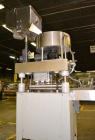 Used Kapsall Model A Inline Screw Capper. Capable of speeds up to 200 bottles per minute. Has dual bottle grippers, three pair spindles and 24
