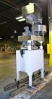 Used Kapsall Model A Inline Screw Capper. Capable of speeds up to 200 bottles per minute. Has dual bottle grippers, three pair spindles and 24