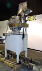 Used Kapsall Model A Inline Screw Capper. Capable of speeds up to 200 bottles per minute. Has dual bottle grippers, three pair spindles and 24