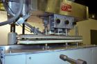 Used Kapsall Model A Inline Screw Capper. Capable of speeds up to 200 bottles per minute. Has dual bottle grippers, three pair spindles and 24
