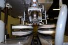 Used Kapsall Model A Inline Screw Capper. Capable of speeds up to 200 bottles per minute. Has dual bottle grippers, three pair spindles and 24