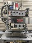 Used- Kapsall Model A Inline Screw Capper. Capable of speeds up to 200 bottles per minute. Has single bottle grippers, three...