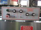 Used KapsAll, Model C-8, Automatic (8) Spindle Capper. Single belt container gripper. Manufacture stated cap size range 8mm-120mm (with proper change parts).