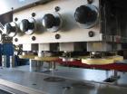 Used KapsAll, Model C-8, Automatic (8) Spindle Capper. Single belt container gripper. Manufacture stated cap size range 8mm-120mm (with proper change parts).