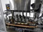 Used Resina Model U40 Automatic Inline Capper. Machine is capable of speeds up to 300 caps per minute. Is a 4 station capper with 8 spindle quills. Adjustable from 10mm-70mm caps. Has top mounted cap...