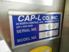 Used Resina Model U40 Automatic Inline Capper. Machine is capable of speeds up to 300 caps per minute. Is a 4 station capper with 8 spindle quills. Adjustable from 10mm-70mm caps. Has top mounted cap...