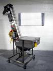 Used Resina Model U40 Automatic Inline Capper. Machine is capable of speeds up to 300 caps per minute. Is a 4 station capper with 8 spindle quills. Adjustable from 10mm-70mm caps. Has top mounted cap...