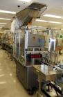 Used Resina Model U40 Automatic Inline Capper. Machine is capable of speeds up to 300 caps per minute. Is a 4 station capper with 8 spindle quills. Adjustable from 10mm-70mm caps. Has top mounted cap...